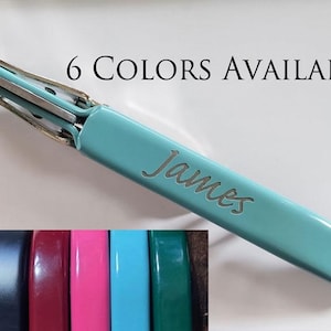 May include: A teal blue bottle opener with the name "James" engraved on it. The bottle opener is made of metal and has a silver finish. The image also shows six different colors of bottle openers, including blue, red, pink, teal, and green.