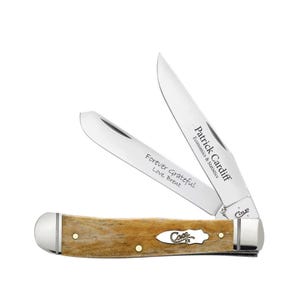 May include: A folding pocket knife with two open stainless steel blades and a textured tan handle. One blade is engraved with "Patrick Cardiff Economics & Statistics" and the other with "Forever Grateful Love, Brent". The handle features a Case logo.