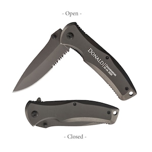 May include: A grey pocket knife with a serrated blade. The knife is shown open and closed in the image. The knife is engraved with the text "DONALD | Groomsman 10-10-2020".