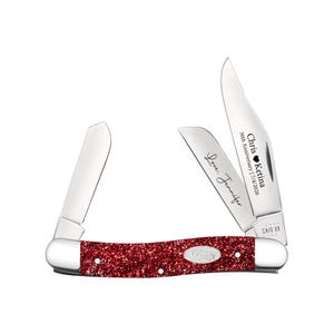May include: A folding pocket knife with a red glitter handle and silver metal bolsters. The knife features two open stainless steel blades. One blade is engraved with the text "Love, Jennifer" and the other with "Chris ❤️ Ketina 30th Anniversary | 7/4/2026".