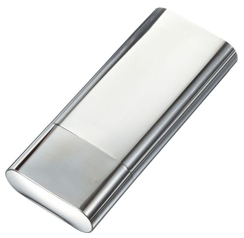 May include: A silver metal case with a rounded edge. The case is closed and has a smooth, reflective surface.