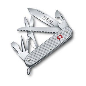 May include: Silver pocket knife with a red cross logo and a personalized inscription that reads "Robert Love you more! - Megan".
