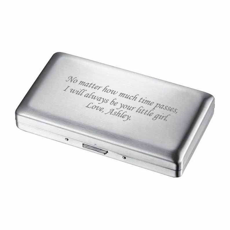 May include: A silver metal box with an engraved message: "No matter how much time passes, I will always be your little girl. Love, Ashley."
