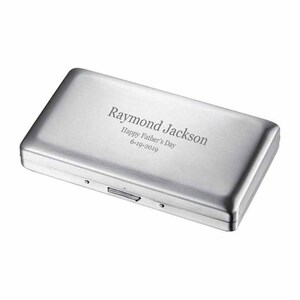 May include: A silver metal cigarette case with an engraved message that reads "Raymond Jackson Happy Father's Day 6-19-2019".