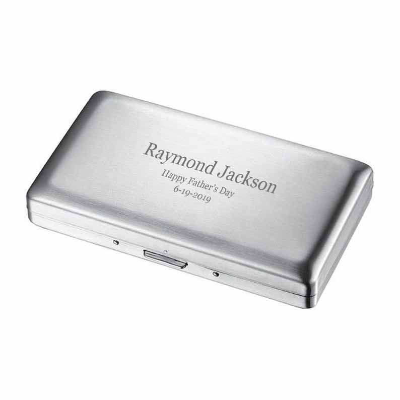 May include: A silver metal cigarette case with an engraved message that reads "Raymond Jackson Happy Father's Day 6-19-2019".