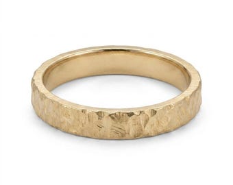 May include: A gold ring with a textured, hammered exterior surface and a smooth, polished interior band. The metal has a warm, yellow metallic finish with visible indentations across the outer circumference, creating a rugged, uneven appearance.