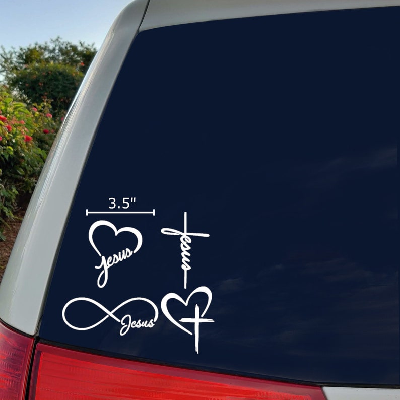 May include: Four white vinyl decals with the word "Jesus" and a heart or cross design. The decals are 3.5 inches tall.