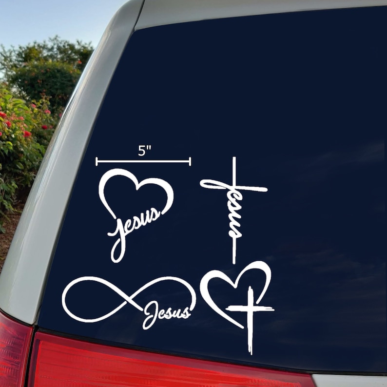 May include: Four white vinyl decals with the word "Jesus" written in a cursive font. The decals feature a heart, a cross, an infinity symbol, and a heart with a cross inside. The decals are 5 inches wide.