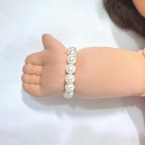 May include: A white ceramic mug with a black handle and the text "But First, Coffee" in a handwritten style. The mug is on a white surface. The mug is approximately 4 inches tall.