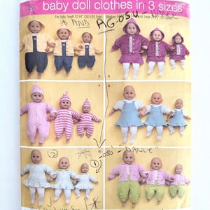 May include: A Simplicity sewing pattern envelope 3572 for baby doll clothes in three sizes, featuring illustrations of dolls wearing various outfits including hooded jackets, overalls, dresses, and pajamas, with handwritten notes and a barcode.