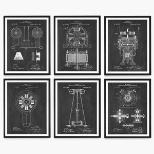 May include: A set of six black and white vintage patent prints featuring illustrations of Nikola Tesla's inventions. The prints are framed in black frames and have a chalkboard background. The prints include the following patent numbers: 568,178, 511,916, 645,576, 465,597, 613,809, and 645,576.