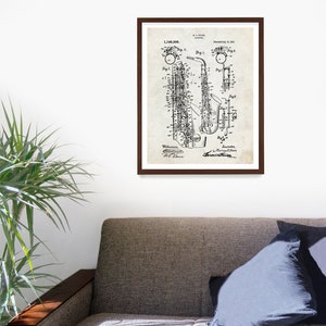 May include: Black and white vintage patent drawing of a saxophone. The patent number is 1,146,508 and the date is July 11, 1915. The drawing shows the saxophone in detail, including the keys, the bell, and the mouthpiece.
