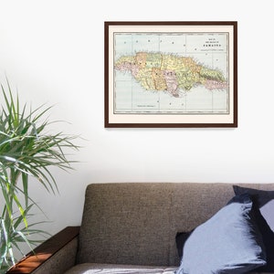 May include: A vintage map of the island of Jamaica, printed in color, with a brown frame. The map shows the island's counties and major cities.