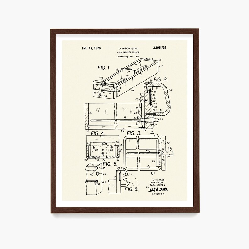 May include: A framed print of a card catalog drawer patent illustration. The black and white drawing includes multiple views and technical details, with text indicating the filing date of Feb. 17, 1970, and the names J. Risom et al.