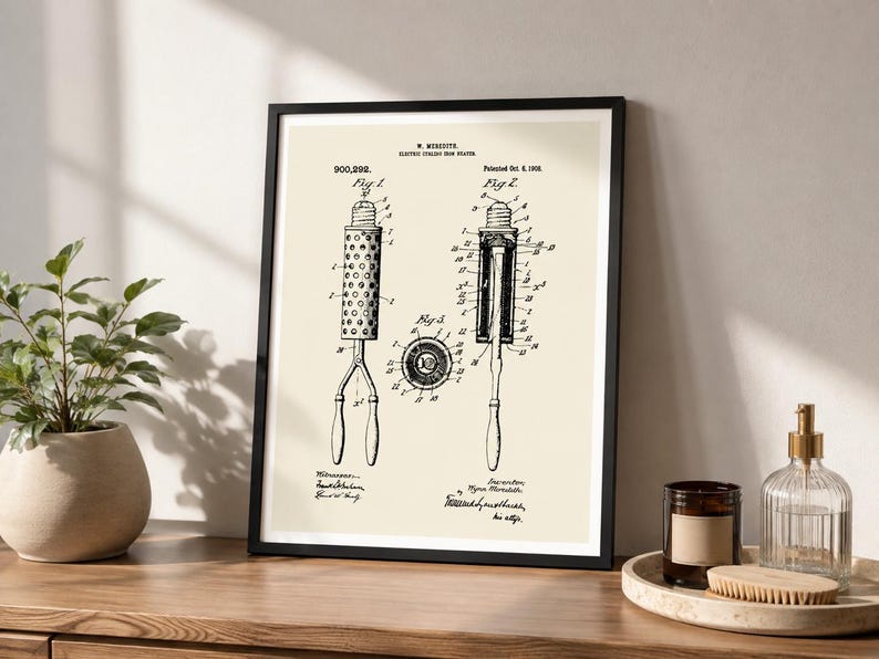 May include: A framed patent print featuring black technical line drawings of an electric curling iron on a cream background. The text includes W. Meredith, Electric Curling Iron, 900,292, Patented Oct. 6, 1908, Fig 1, Fig 2, and Fig 3 with labels.