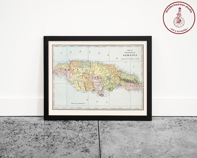 May include: A vintage map of the island of Jamaica, printed in color with a black frame. The map shows the island's parishes and includes the title "Map of the Island of Jamaica".