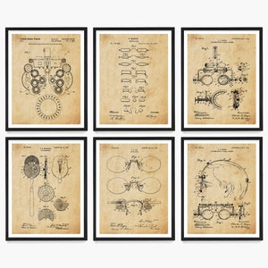 May include: Set of six framed vintage patent prints featuring detailed illustrations of eye examination equipment and eyeglasses. The prints are in black and white on a tan background, with black frames. Each print showcases technical drawings and diagrams.