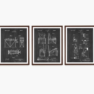 May include: Three black and white patent drawings in brown frames. The drawings depict different exercise machines. The first drawing shows a machine for exercising the arms and legs. The second drawing shows a machine for exercising the back and shoulders. The third drawing shows a machine for exercising the legs and feet.