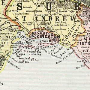May include: A vintage map of Jamaica, showing the location of Kingston and surrounding areas. The map is printed in black and white with colored borders and highlights. The map includes the names of towns, rivers, and other geographical features.