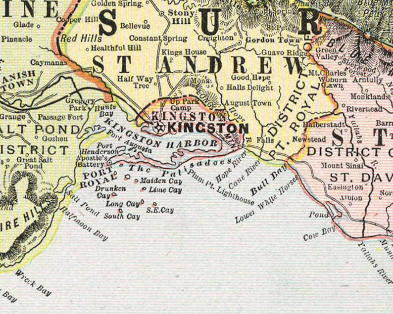 May include: A vintage map of Jamaica, showing the location of Kingston and surrounding areas. The map is printed in black and white with colored borders and highlights. The map includes the names of towns, rivers, and other geographical features.