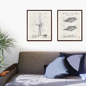 May include: Two black and white vintage patent drawings in brown frames. The left drawing shows a windmill design. The right drawing shows a solar panel design. The drawings are on a white wall above a brown couch.
