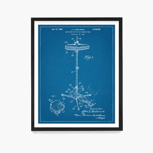 May include: A blue and white blueprint of a patent for an anti-slide lock for an actuator pedal. The patent is titled "Anti-Slide Lock for an Actuator Pedal" and was filed on December 21, 1962. The patent number is 3,118,339. The patent drawing shows a hi-hat stand with a cymbal and a foot pedal.