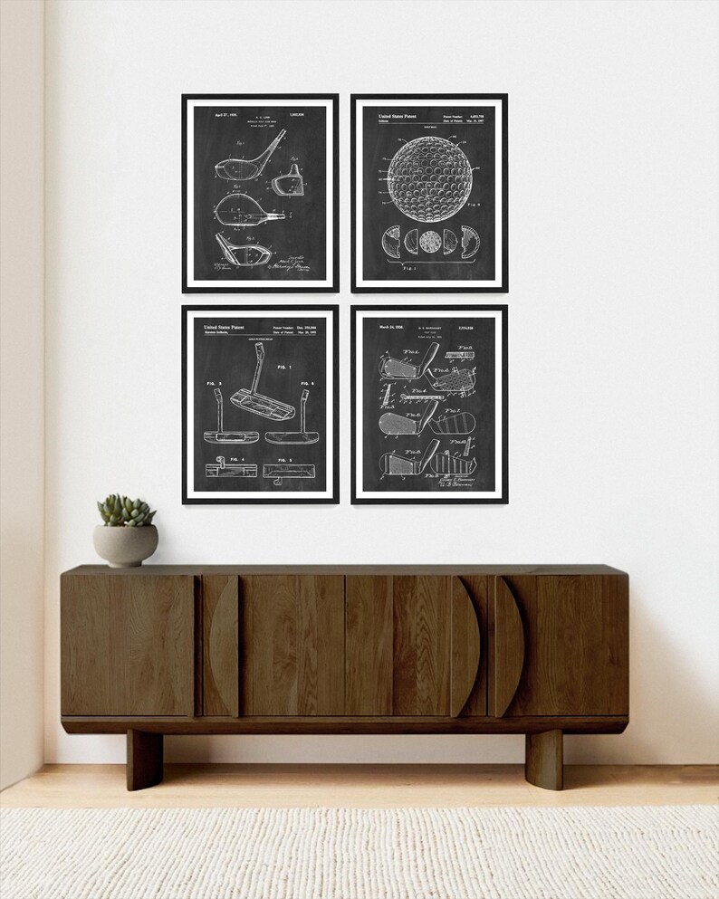 May include: Set of four black and white vintage patent prints featuring golf equipment. The prints depict a golf club, a golf ball, and a golf putter. The prints are framed and displayed on a wall above a dark brown wooden cabinet.