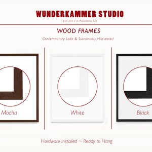 May include: Three wood picture frames against a white background. The frames are shown in mocha, white, and black. The text "Mocha", "White", and "Black" is below each frame. The text "WUNDERKAMMER STUDIO" is at the top of the image. The text "Est. 2013 in Pasadena, CA" is below the studio name. The text "WOOD FRAMES" is below the studio address. The text "Contemporary Look & Sustainably Harvested" is below the frame type. The text "Hardware Installed ~ Ready to Hang" is at the bottom of the image.