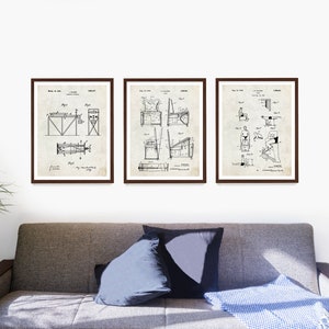 May include: Three framed vintage patent drawings of exercise equipment. The drawings are in black and white and show different types of exercise equipment, including a rowing machine, a weight machine, and a stationary bike. The drawings are on a white background and are framed in brown frames.