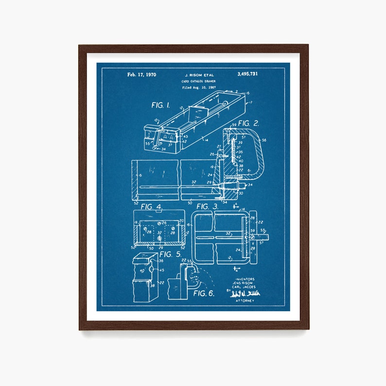 May include: A framed blueprint of a card catalog, dated February 17, 1970. The detailed technical drawing, in white on a blue background, includes multiple views and labels. The frame is a dark brown color.