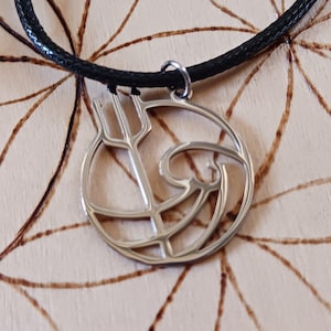 May include: A silver necklace with a black cord and a pendant featuring a stylized wave and trident design.