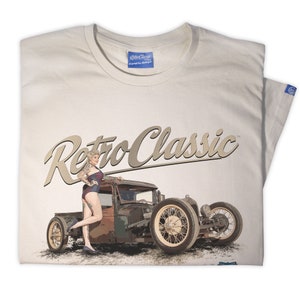 May include: A white t-shirt with a vintage-style illustration of a woman standing next to a hot rod truck. The text "Retro Classic" is printed in brown above the image.