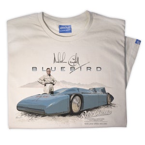 May include: A beige t-shirt featuring a blue and white illustration of a land speed record car called "Bluebird" and a signature from Malcolm Campbell. The text "Retro Classic Campbell Heritage Collaboration 1935 Land Speed Record" is printed below the car.