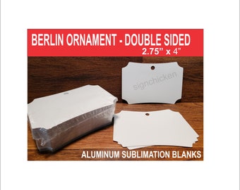 May include: A stack of white aluminum sublimation blanks for ornaments. The blanks are 2.75 inches by 4 inches and have a hole for hanging. The text "BERLIN ORNAMENT - DOUBLE SIDED 2.75" x 4" signchicken ALUMINUM SUBLIMATION BLANKS" is printed on the image.