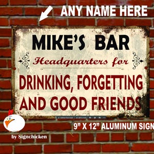 May include: A rustic-style metal sign with a distressed finish. It reads "Mike's Bar Headquarters for Drinking, Forgetting and Good Friends". The sign is 9 inches by 12 inches and is made of aluminum.