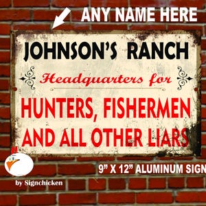 May include: A rustic-style metal sign with a white background and red text. It reads "Johnson's Ranch Headquarters for Hunters, Fishermen and All Other Liars". The sign is 9 inches by 12 inches and is made of aluminum.