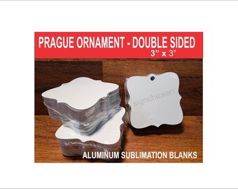 May include: A stack of white, 3 inch by 3 inch, double-sided aluminum sublimation blanks in the shape of a Prague ornament. The blanks have a hole at the top for hanging. The text "signchicken" is printed on one of the blanks. The text "PRAGUE ORNAMENT - DOUBLE SIDED 3" x 3" ALUMINUM SUBLIMATION BLANKS" is printed on a red banner.