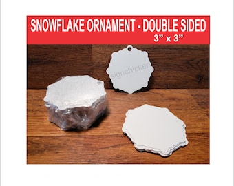 May include: A stack of white snowflake ornament blanks, 3 inches by 3 inches, with a hole for hanging. The ornaments are double-sided and ready to be decorated.