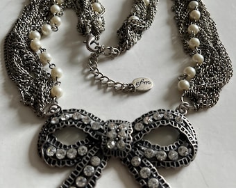 Vintage necklace rhinestone bow pendant on multi-strand silver tone chains with pearl accent and EFM tag