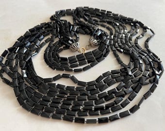 Vintage Black Lucite flapper necklace.  58” long