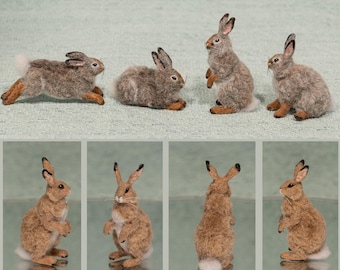 May include: A collection of nine hand-crafted felt rabbit figurines. The rabbits are in various poses, including standing, sitting, and lying down. The rabbits are all brown and gray in color.