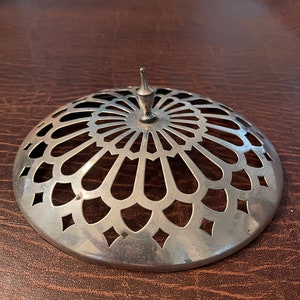 May include: Silver dome-shaped cover with a decorative cut-out design and a small finial on top.