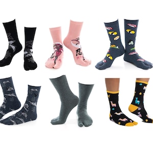May include: Six pairs of split-toe tabi socks in various colors and patterns, including black with white graphics, pink with ninja illustrations, dark gray with sushi prints, blue with fish motifs, solid dark gray, and black with colorful llama designs.