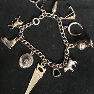 Antique Sterling silver charm bracelet w/ 11 Sterling Silver charms marked Sterling