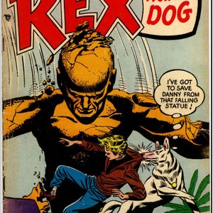 Op de afbeelding: Een comicboekomslag met een rode en witte titel "The Adventures of Rex the Wonder Dog". De omslagillustratie toont een groot, bruin, mensachtig figuur met een gebarsten hoofd, een jongen in een blauwe spijkerbroek en een bruin shirt, en een witte hond. De tekst op de omslag luidt "I've got to save Danny from that falling statue!" en "Rex Battles Startling Dangers in... "The Secret of the Vanishing Island!"