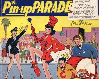 May include: A vintage comic book cover featuring Katy Keene, a pin-up girl in a red and white marching band uniform, holding a baton. The cover is titled "Katy Keene Pin-up Parade" and features the text "All New Stories" and "Free 1955 Pin-up Calendars".