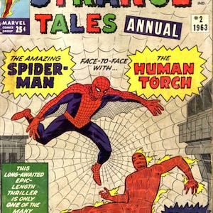 May include: A comic book cover featuring Spider-Man and the Human Torch. The cover is yellow with red, green, and blue text. The text reads "Strange Tales Annual #2 1963". The cover features a red and blue Spider-Man swinging through the air, and a red Human Torch with flames coming from his body. The text "The Amazing Spider-Man" and "The Human Torch" are in yellow boxes with black outlines.