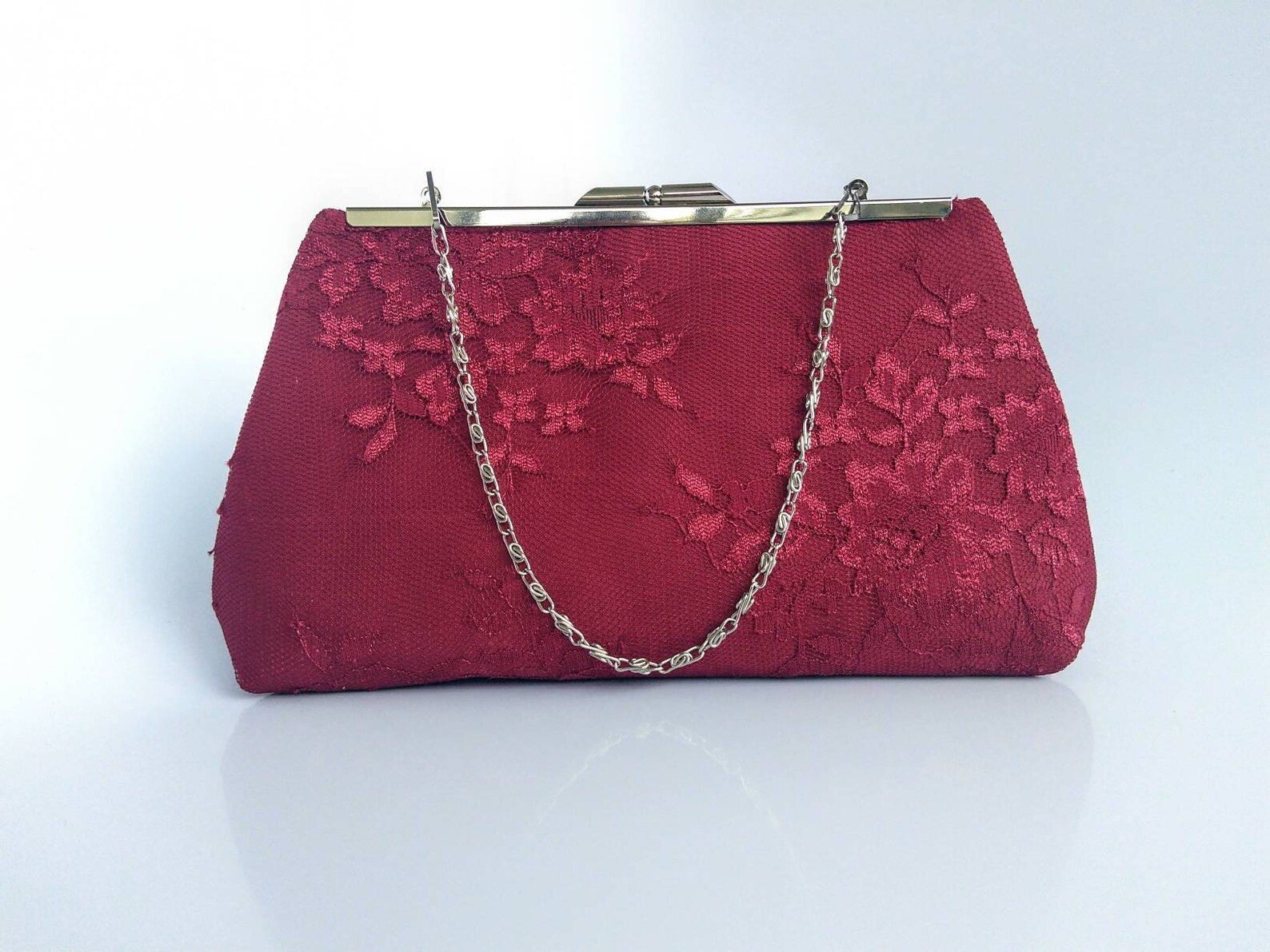 burgundy and gold clutch bag