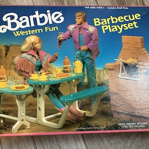 May include: A vintage Barbie Western Fun Barbecue Playset box. The box features Barbie and Ken dolls, a picnic table, and a brick barbecue grill. The box is pink and blue with the Mattel logo.