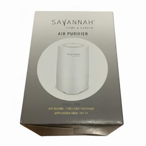 May include: A white air purifier in a box. The box is gray and white with the words "SAVANNAH HOME & GARDEN AIR PURIFIER" printed on it. The air purifier is cylindrical and has the brand name printed on it. The box also states the air volume is 1765 cubic feet/hour and the application area is 107 SF.
